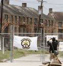 A man photographs the shuttered St. Bernard low-income housing project in July 2006, almost one year after Hurricane Katrina flooded this area of the city. New Orleans public housing residents recently filed a civil rights lawsuit against the city's housing authority and HUD.