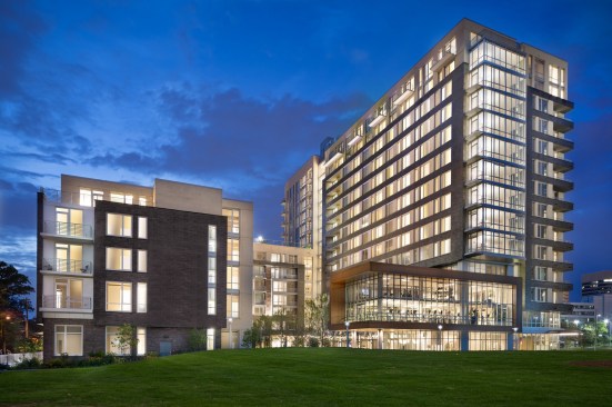Three buildings of different heights and with large glass expanses and balconies minimize The Pearl's massing and allow it to fit in with the surrounding residential neighborhood. The structures also provide enough density to maximize the site for apartments and amenity spaces.