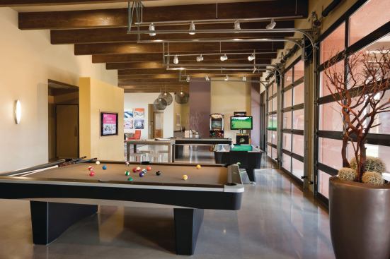 TOGETHERNESS: Since being together was tops on most students’ wish lists, the property includes attractive gathering spaces, with a state-of-the-art game room and garage-style glass doors that lift up to meld indoors with outdoors. 