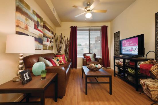 CHIC LIVING: Privacy, also, was requested for the new space, and each of the apartments contains a living room, kitchen, washer–dryer, and four bedrooms—all with private bathrooms for each student. Here, too, finishes were made to look attractive yet remain durable: vinyl plank rather than wood flooring; sofas and lounge chairs upholstered in leatherlike, durable fabrics; and metal feet for furniture.


