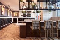 Residents at Notion in Decatur, Georgia, enjoy an elegant mailroom with a work-from-home area and a built-in coffee station.